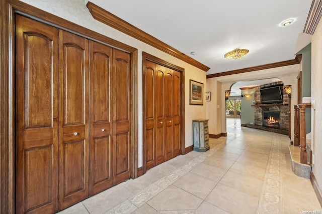 hallway with light tile patterned floors and ornamental molding