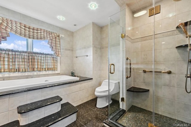 bathroom featuring shower with separate bathtub, toilet, and tile walls