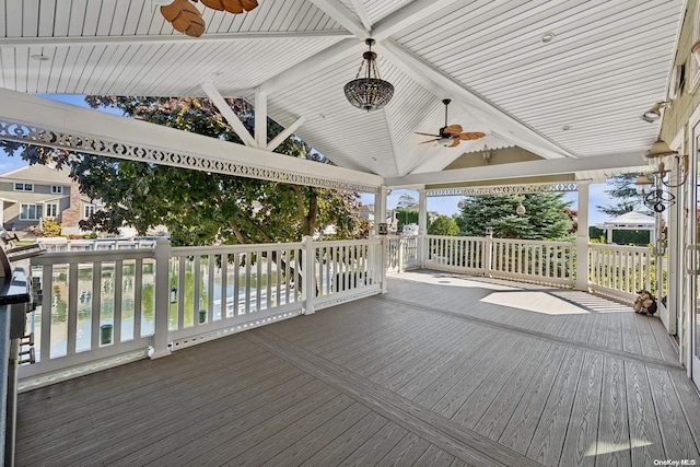 wooden deck with ceiling fan and a water view