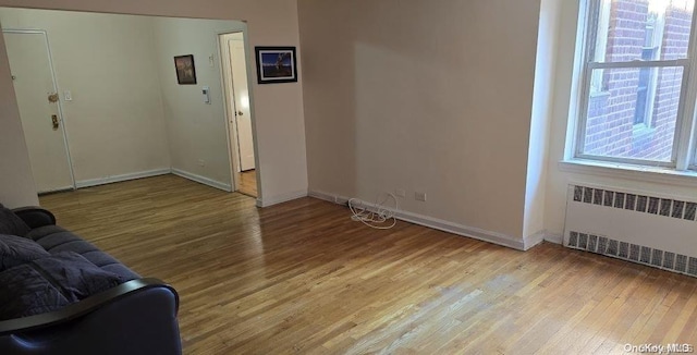 living room with radiator and light hardwood / wood-style floors