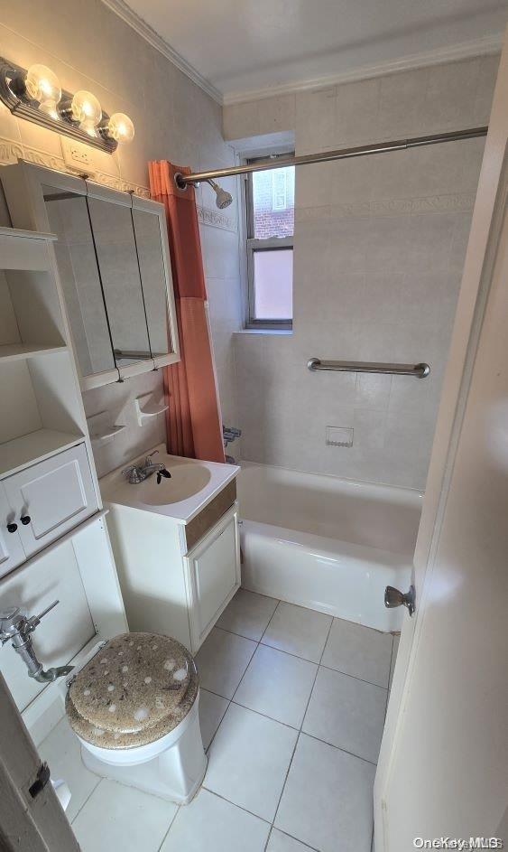 full bathroom with vanity, tile patterned floors, tiled shower / bath, toilet, and ornamental molding