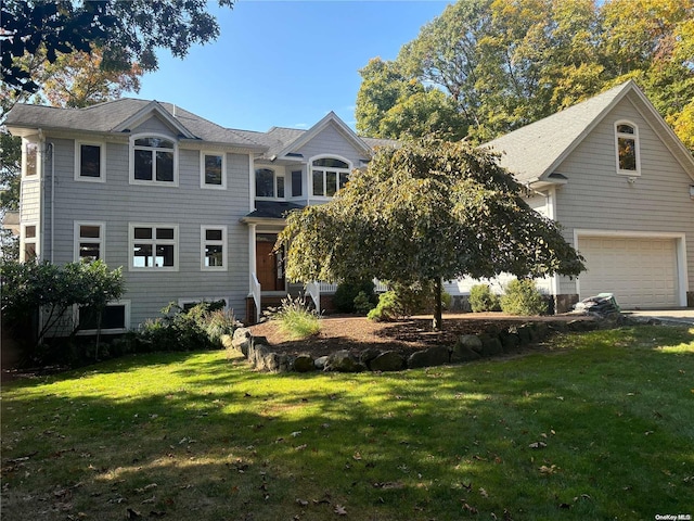 view of front of property with a garage and a front yard