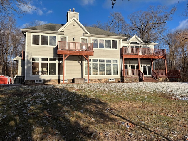 back of house with a sunroom, a wooden deck, and central air condition unit