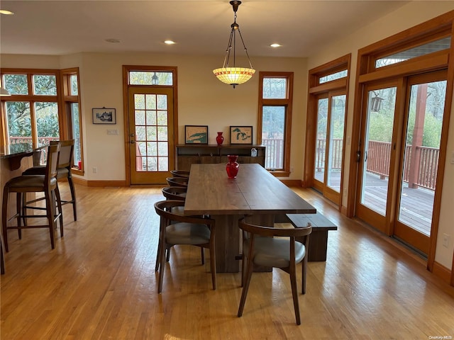 dining area with french doors and light hardwood / wood-style floors