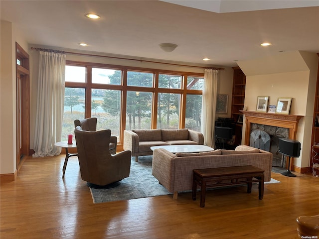 living room with light wood-type flooring and a fireplace