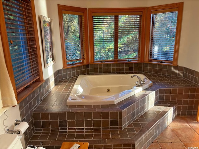 bathroom featuring tile patterned flooring and tiled bath