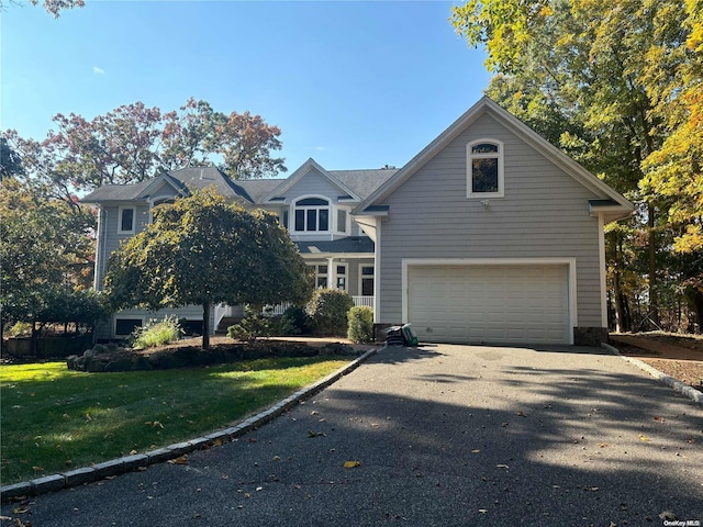 view of front of house featuring a front yard and a garage