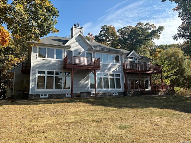 back of house with a lawn and a deck