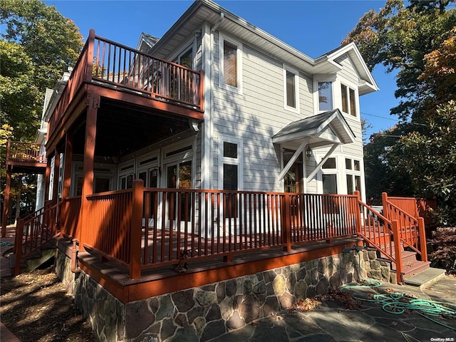 back of house featuring a wooden deck