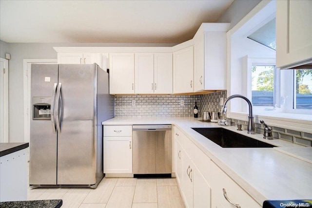 kitchen featuring white cabinetry, sink, and appliances with stainless steel finishes