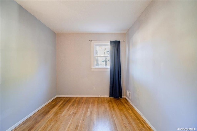 spare room featuring light hardwood / wood-style flooring