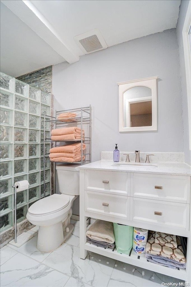 bathroom featuring walk in shower, vanity, and toilet