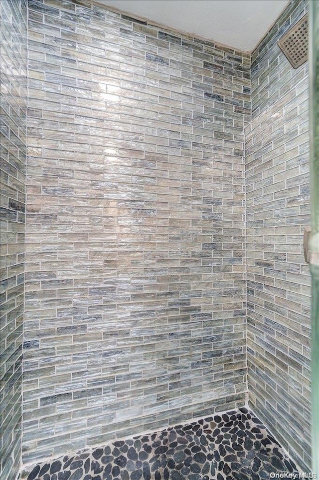 bathroom with a tile shower