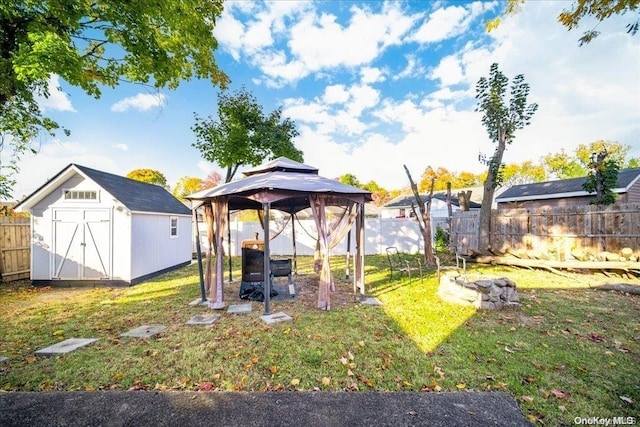 view of yard featuring a gazebo and a storage unit