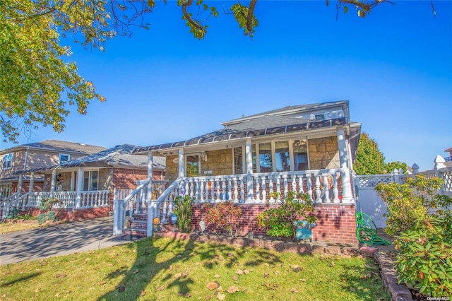 view of front of property with a front yard and a porch