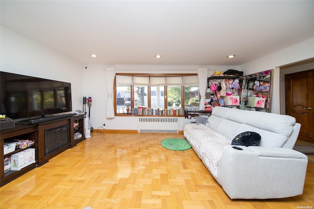 living room with radiator heating unit and light parquet flooring