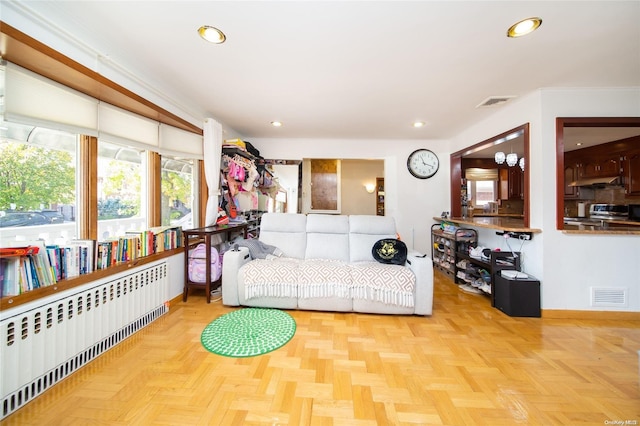 living room with light parquet flooring and radiator