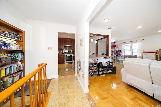 corridor with crown molding and light parquet flooring