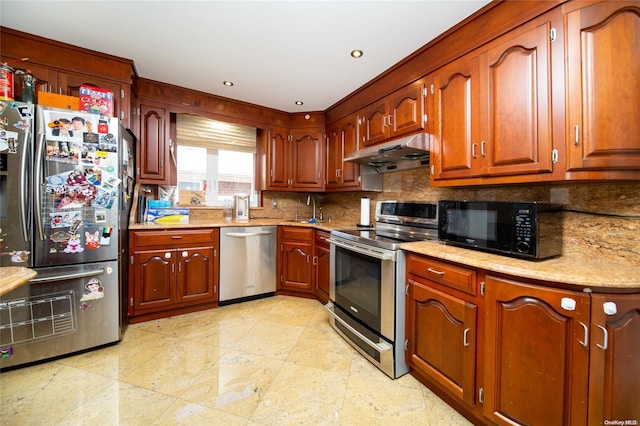 kitchen featuring stainless steel appliances, tasteful backsplash, and sink