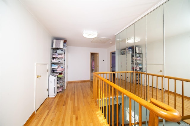 hallway with hardwood / wood-style flooring and ornamental molding