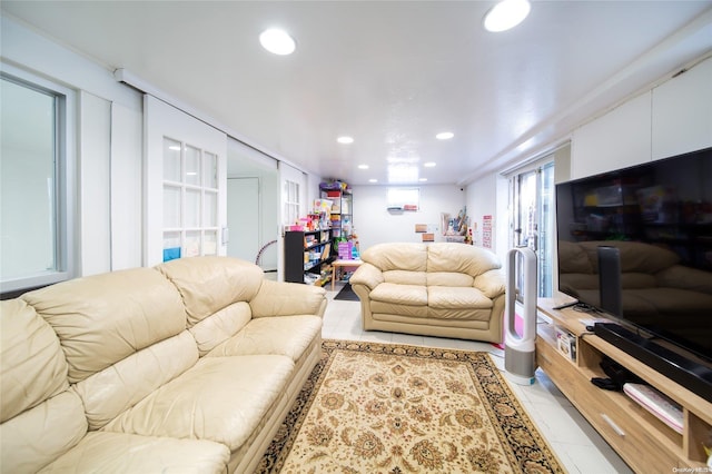 living room featuring crown molding and light tile patterned flooring