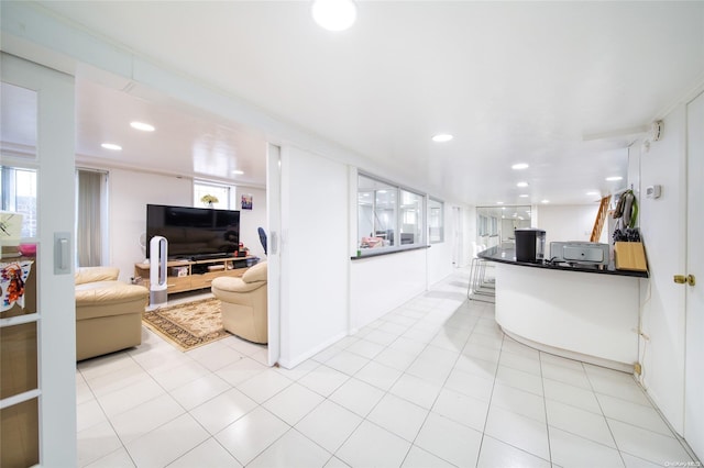 kitchen featuring white cabinets and light tile patterned flooring