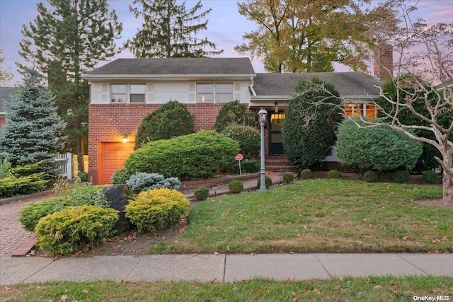 view of front of house featuring a lawn and a garage