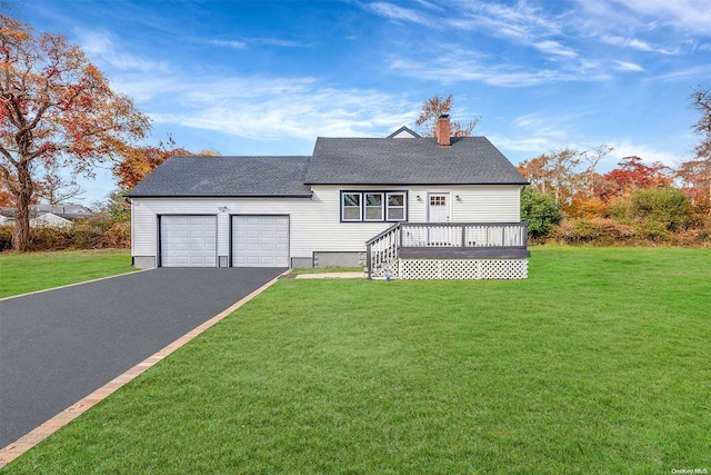 view of front of house with a garage and a front lawn