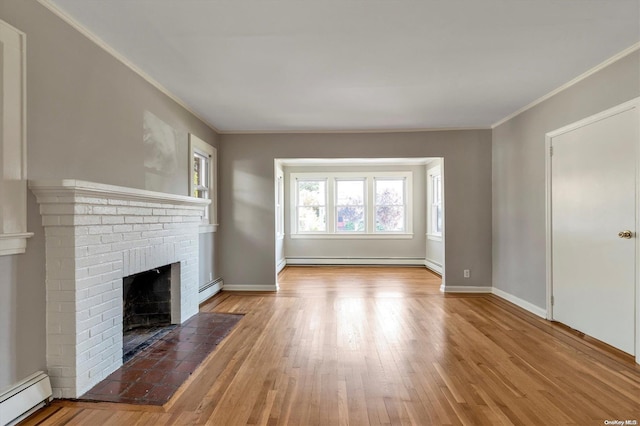 unfurnished living room featuring crown molding, a brick fireplace, and a baseboard heating unit