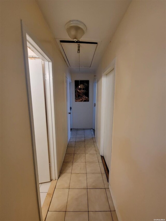 hall featuring light tile patterned floors