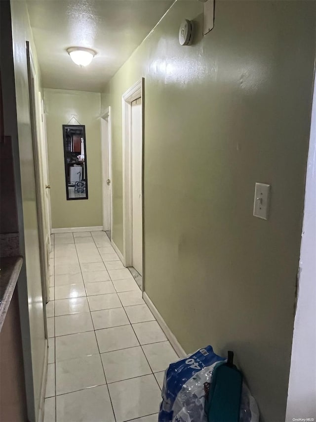 hall featuring light tile patterned floors