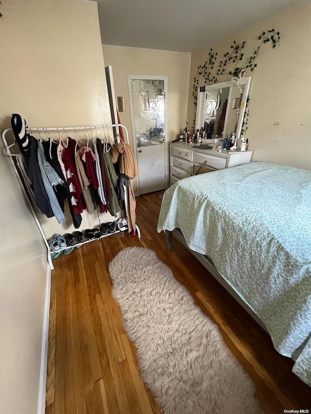 bedroom with hardwood / wood-style flooring