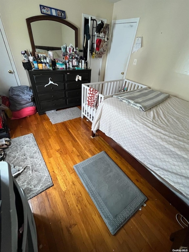 bedroom with hardwood / wood-style floors