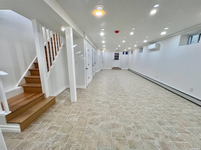 basement featuring a wall mounted AC and a baseboard heating unit