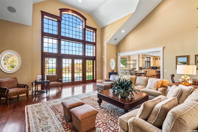 living room featuring french doors, high vaulted ceiling, and dark wood-type flooring