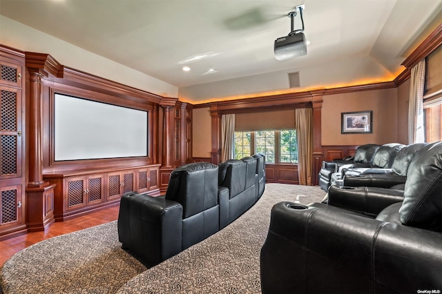 cinema featuring hardwood / wood-style floors and ornate columns