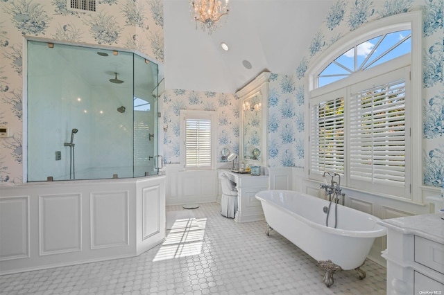 bathroom featuring vanity, an inviting chandelier, separate shower and tub, and plenty of natural light