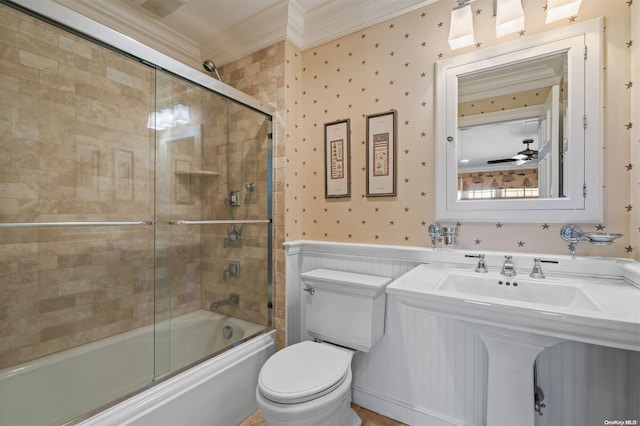 bathroom with crown molding, ceiling fan, enclosed tub / shower combo, and toilet