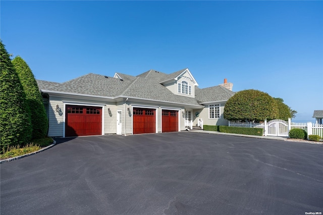 cape cod-style house featuring a garage