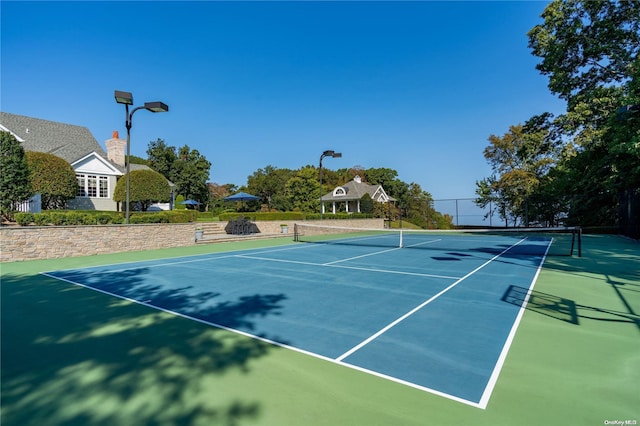 view of sport court with basketball hoop