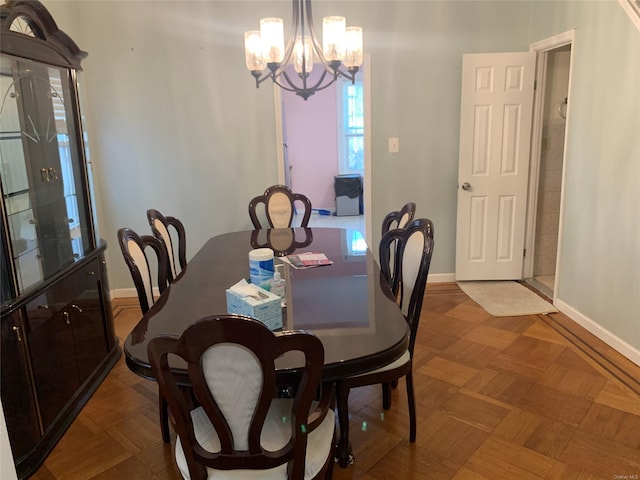 dining area with parquet floors and a chandelier