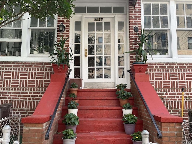 property entrance featuring brick siding