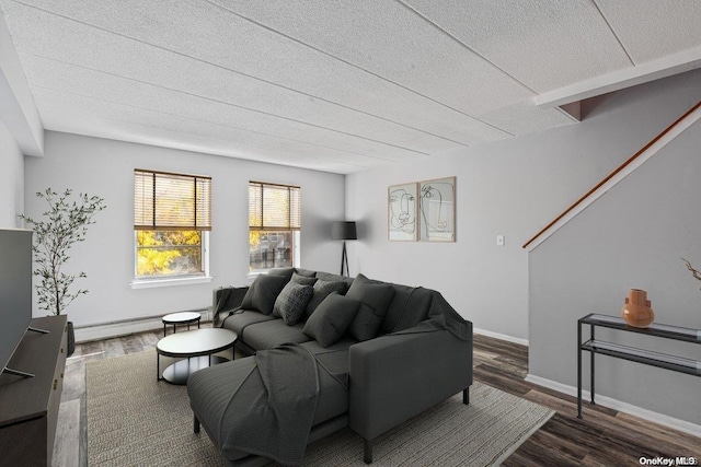 living room with dark hardwood / wood-style floors, a textured ceiling, and a baseboard heating unit