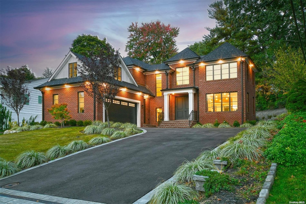 view of front facade featuring a yard and a garage