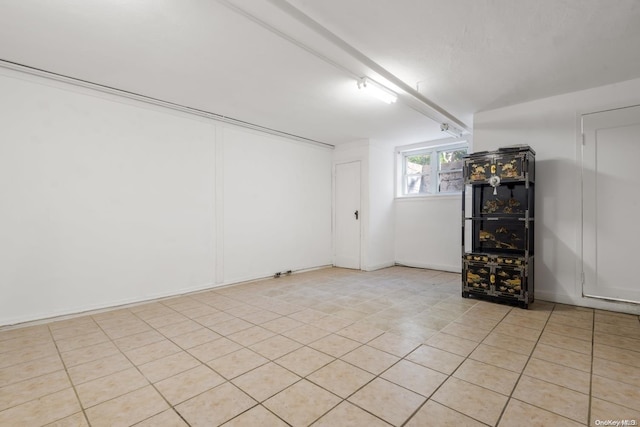 basement featuring light tile patterned flooring