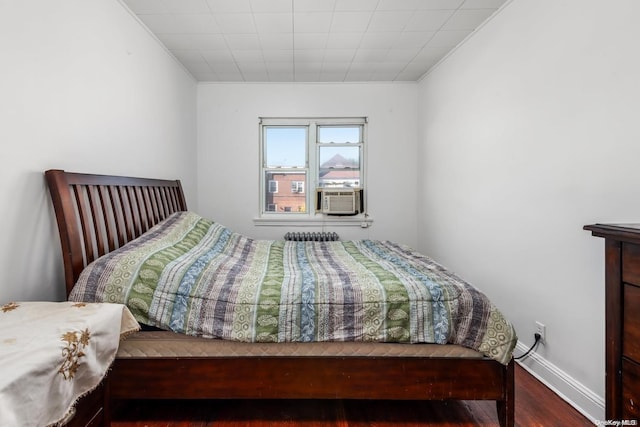 bedroom with hardwood / wood-style floors, cooling unit, and ornamental molding