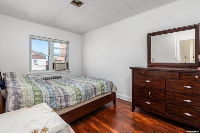 bedroom featuring cooling unit and dark hardwood / wood-style floors