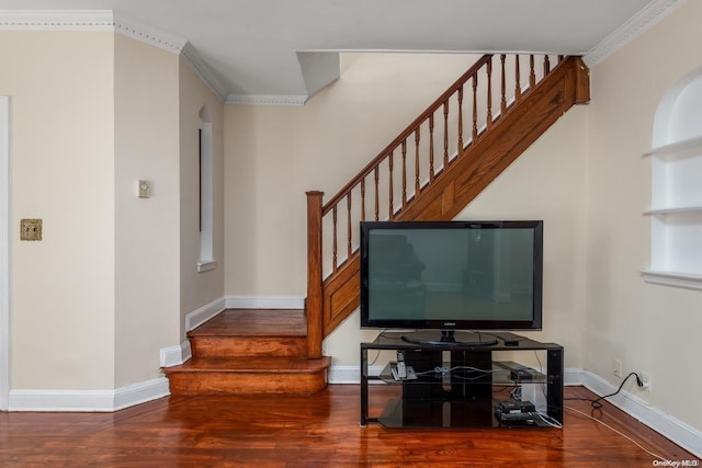 stairway featuring wood-type flooring and ornamental molding