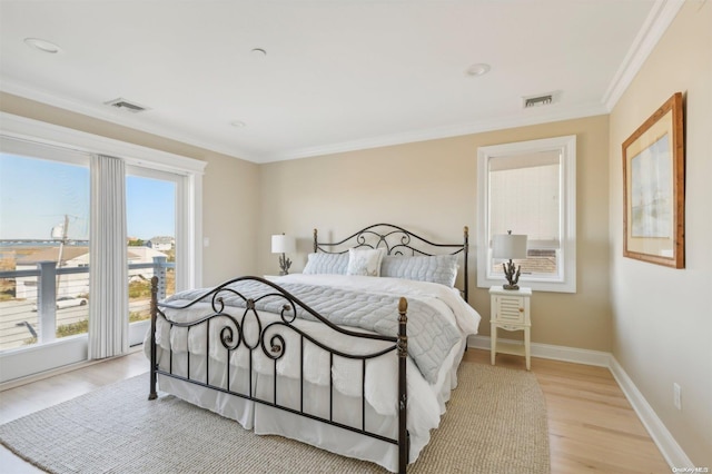 bedroom featuring light hardwood / wood-style flooring and ornamental molding