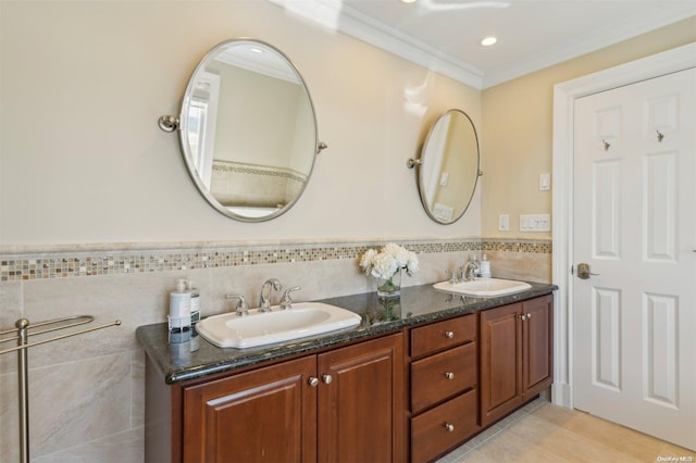 bathroom featuring tile patterned floors, crown molding, vanity, and tile walls